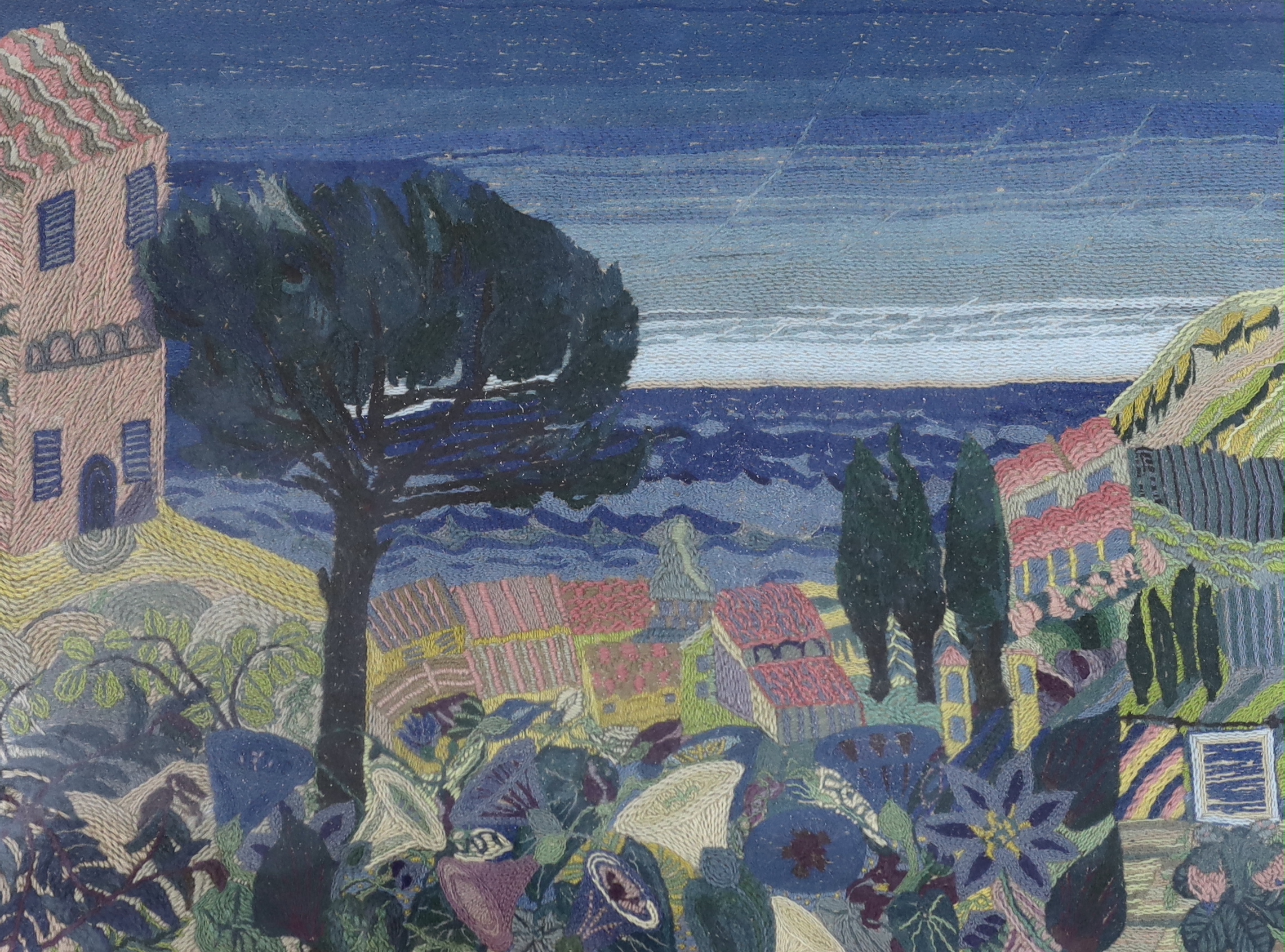 A framed woolwork scene, continental landscape with villas